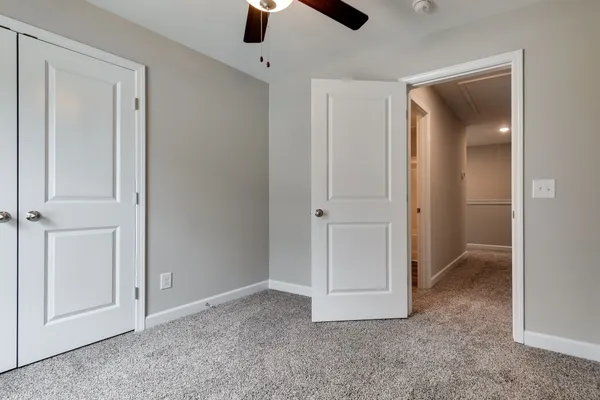 an empty room with ceiling fan