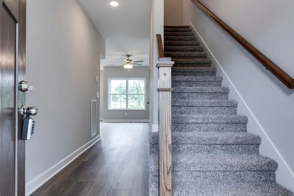 a view of entryway and hall with wooden floor