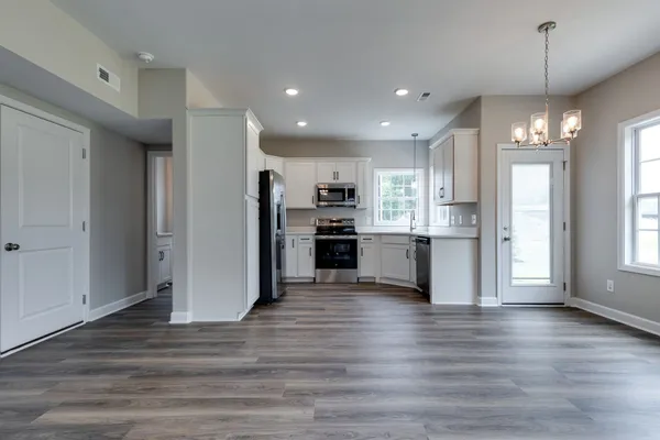 a view of kitchen with refrigerator and window