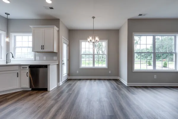 a kitchen with stainless steel appliances granite countertop wooden floors and sink
