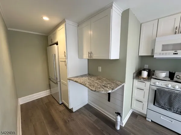 a kitchen with a stove a refrigerator and a sink
