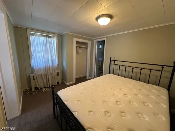 a bed sitting in a bedroom next to a window