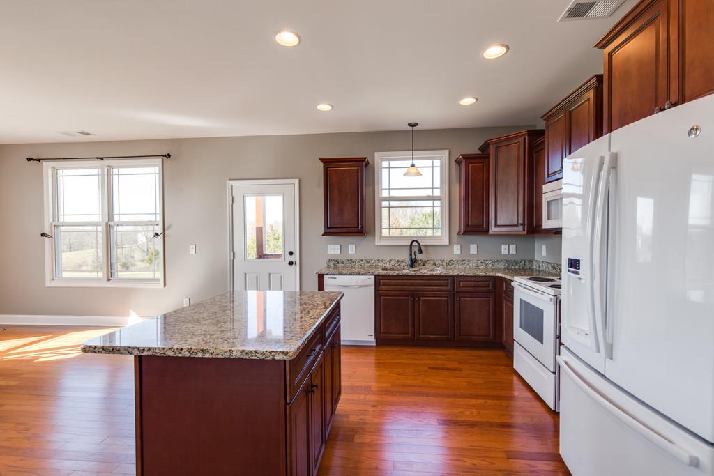 5482 Hickory Ridge Road Lebanon, TN 37090 - Photo 10 of 23 a large kitchen with granite countertop a large center island and stainless steel appliances