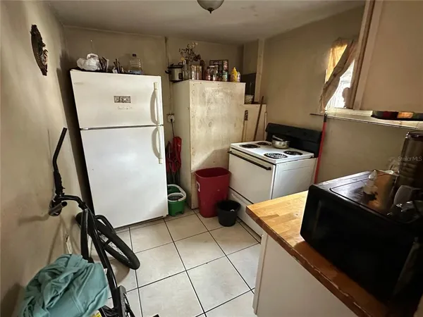a kitchen with a refrigerator and a stove top oven