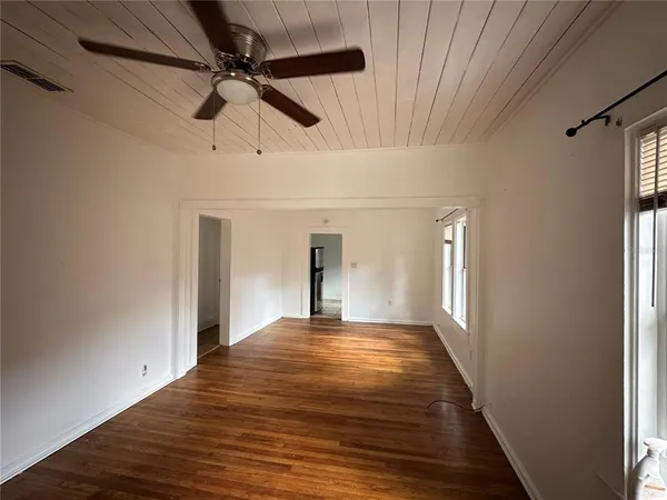 a view of a livingroom with a ceiling fan and window