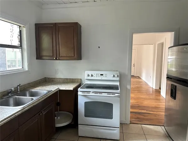 a kitchen with a stove sink and refrigerator
