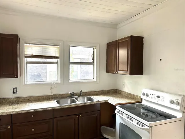 a kitchen that has a sink and a stove