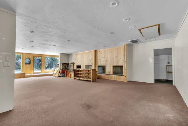 a view of a livingroom with furniture and a fireplace