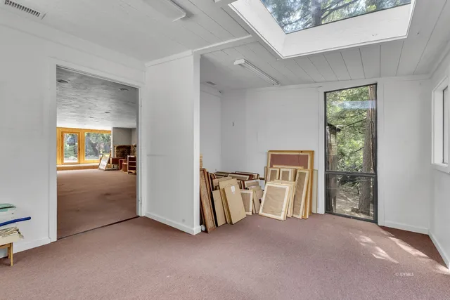 a view of empty room with furniture and floor to ceiling window