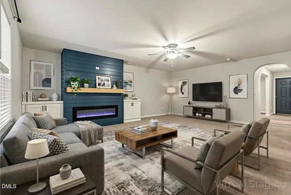 a living room with furniture and a fireplace