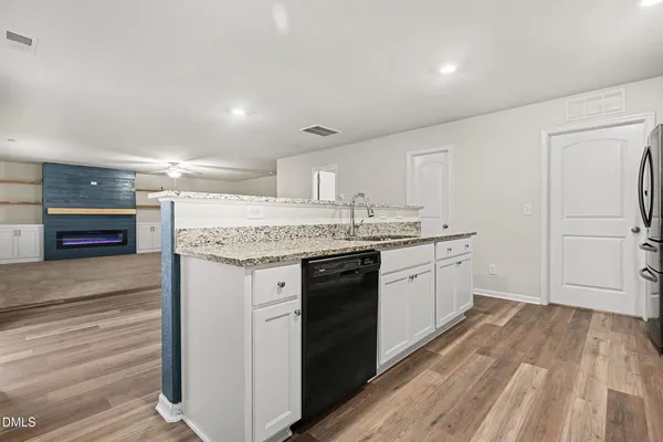 a kitchen with a sink window and stainless steel appliances
