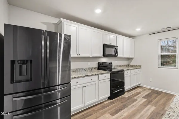a kitchen with a refrigerator stove and microwave