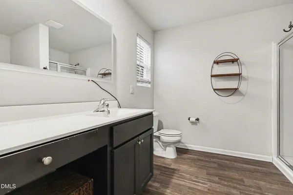 a bathroom with a sink a toilet and a mirror