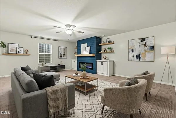 a living room with furniture a fireplace and a window