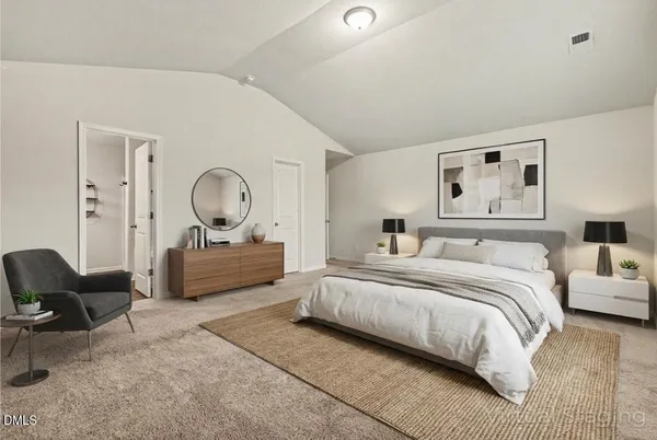 a bedroom with bed mirror and window