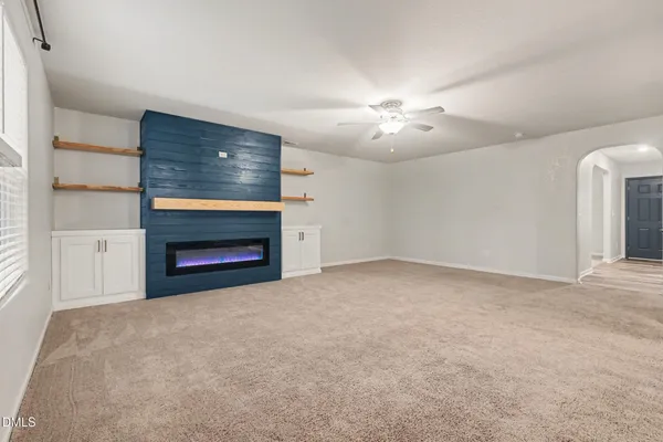 a view of empty room with a fireplace