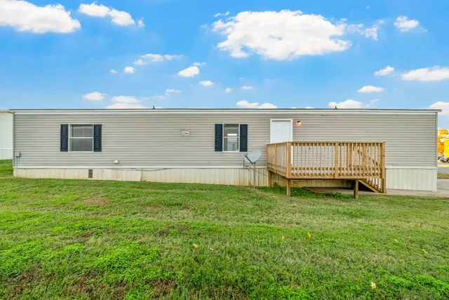 a view of a backyard with a garden and deck
