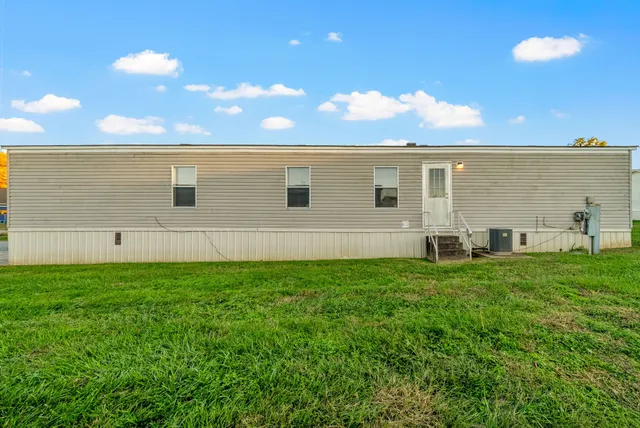a view of a backyard with plants and an ocean view