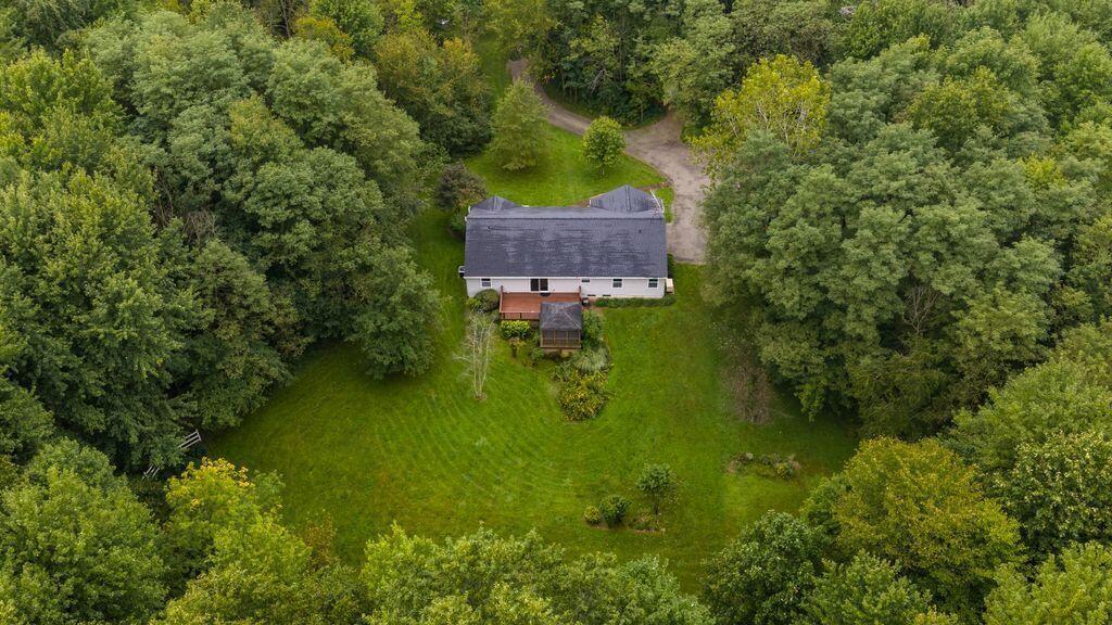 Nestled in the woods with plenty of green grass and space to garden