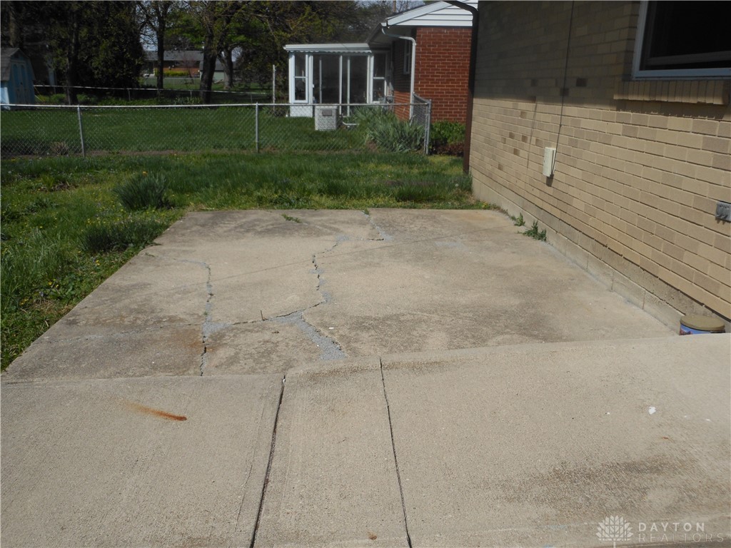 143 West Emerick Road West Milton, OH 45383 - Photo 28 of 37 This property features a sturdy brick exterior and a concrete patio, perfect for outdoor enjoyment.