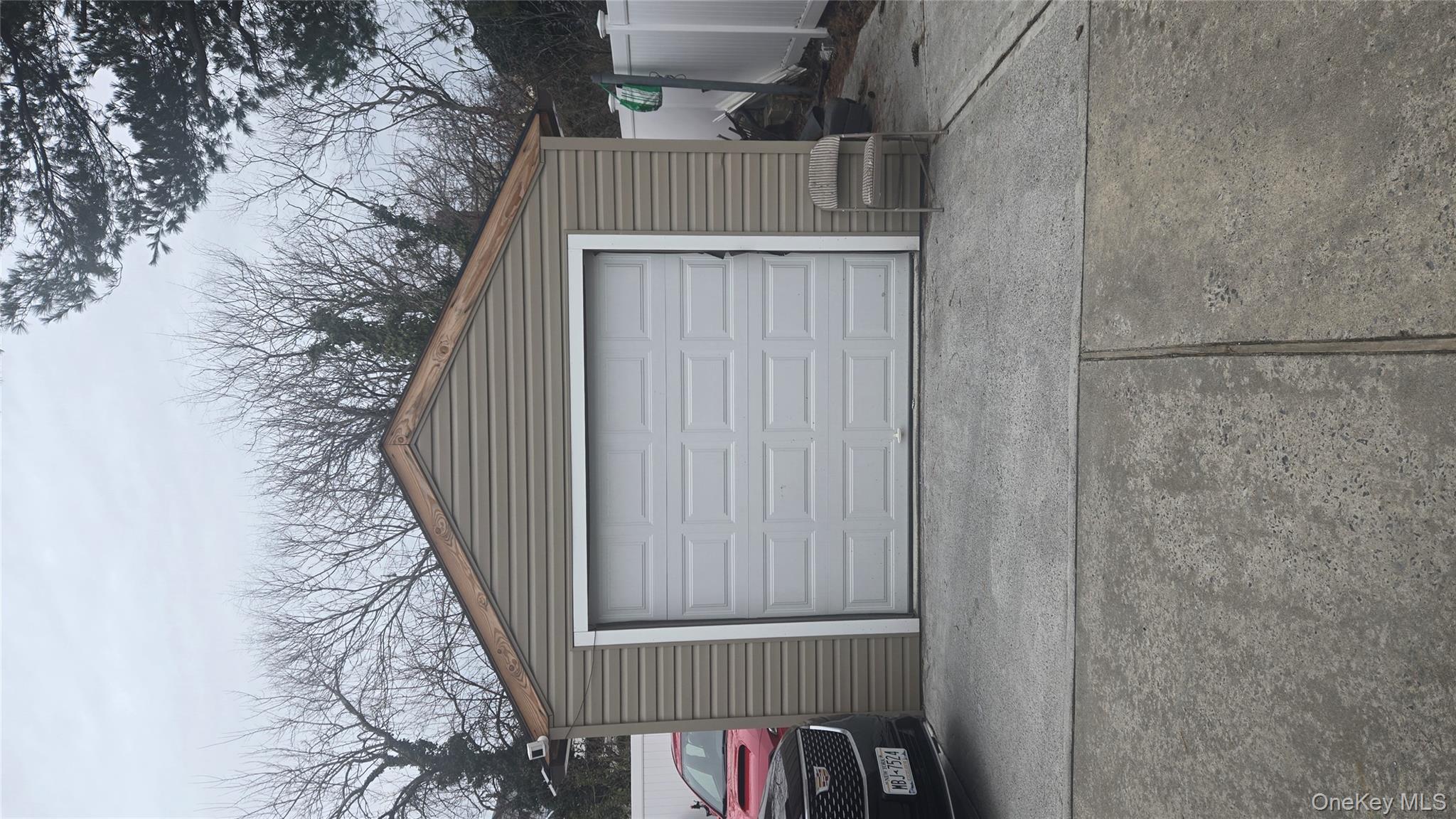 277 Elmont Road Elmont, NY 11003 - Photo 3 of 7 a view of garage and a car parked in it