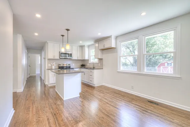 a kitchen with a refrigerator window and wooden floor