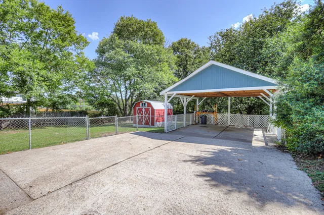 a view of a backyard with a garden and entertaining space