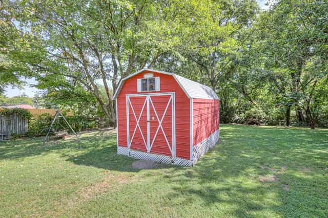 a view of a field with trees in the background