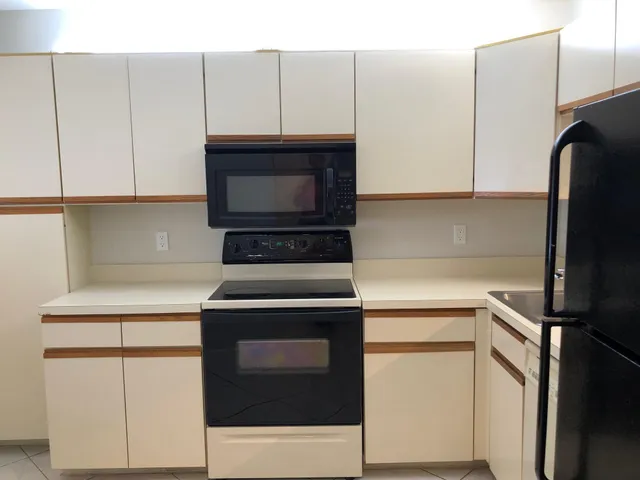 a kitchen with cabinets and appliances