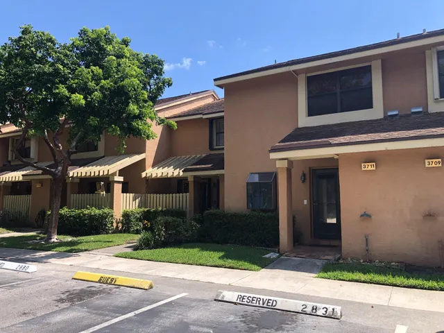 a front view of a house with a yard and a garage