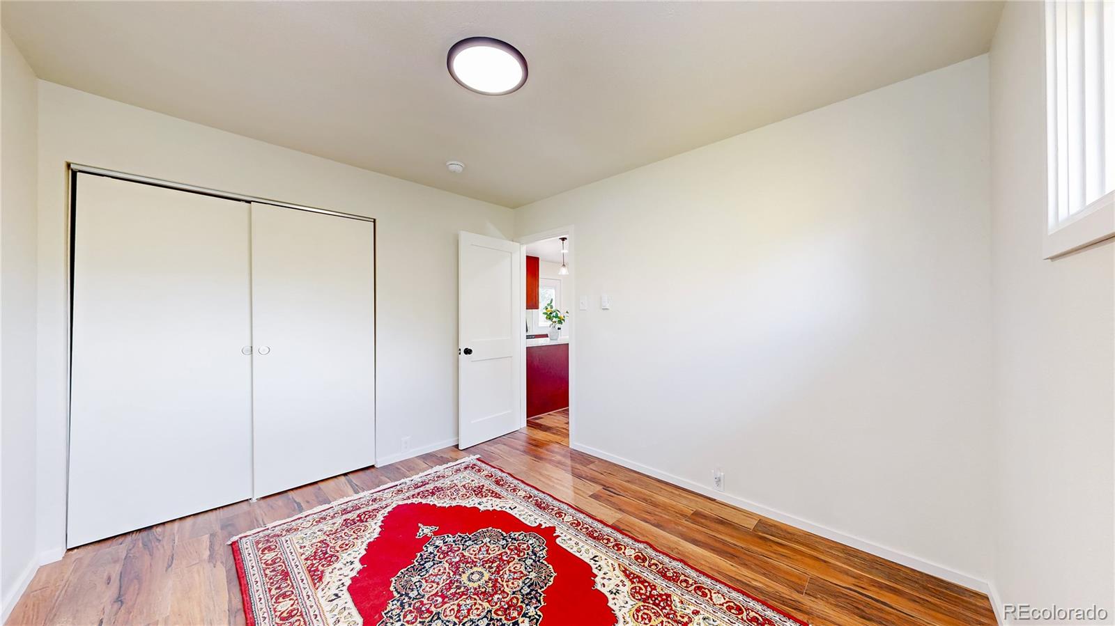 225 Renaud Road Bailey, CO 80421 - Photo 18 of 39 a bedroom with a bed and a painting on the wall