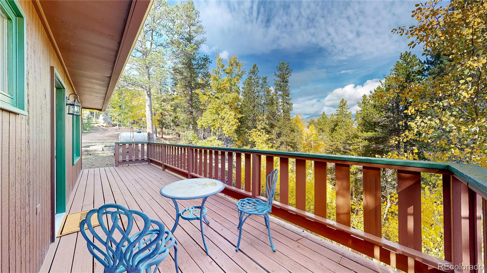 225 Renaud Road Bailey, CO 80421 - Photo 21 of 39 a view of a chairs on wooden deck