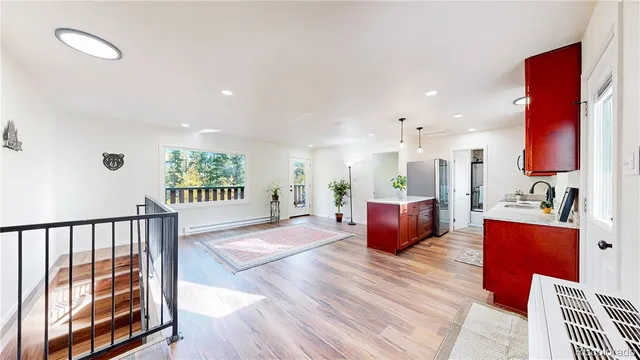 a living room with furniture wooden floor and a large window