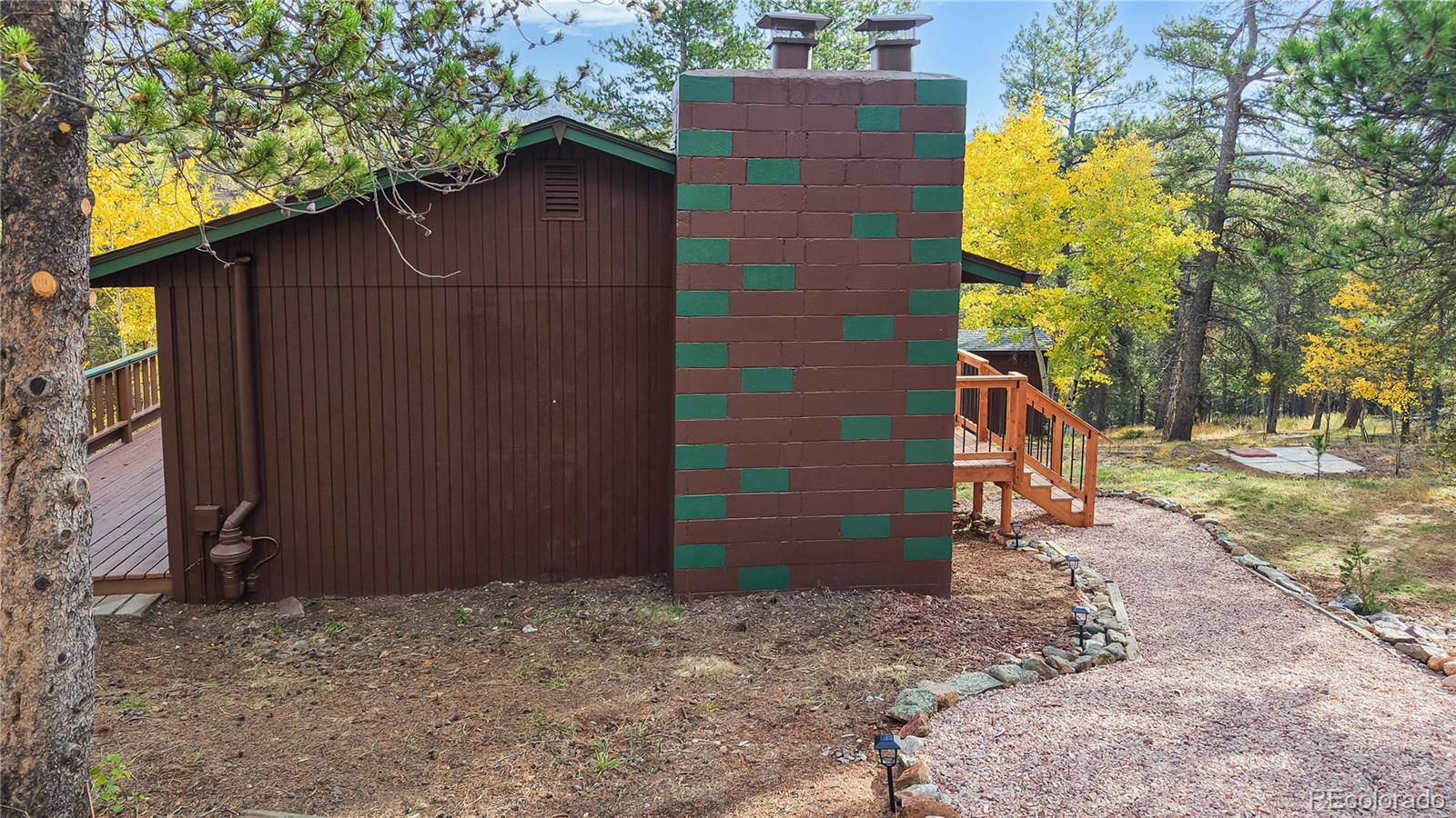 225 Renaud Road Bailey, CO 80421 - Photo 38 of 42 a backyard of a house with a tree beside it