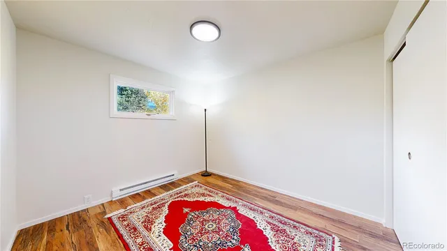 a view of a room with wooden floor