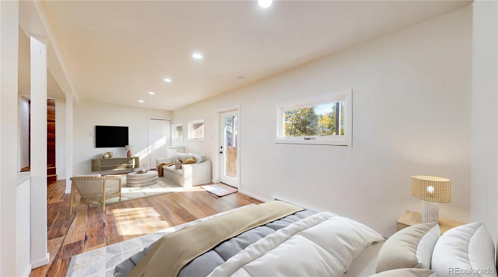 225 Renaud Road Bailey, CO 80421 - Photo 9 of 42 a bedroom with a bed and a flat screen tv