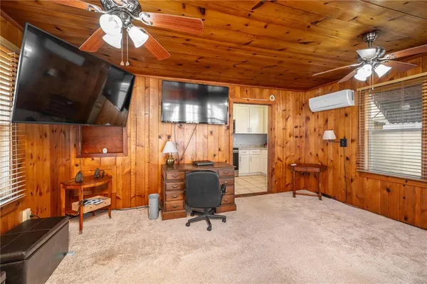 a view of an empty room with a fireplace and a window