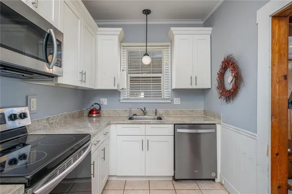a kitchen with a sink cabinets and appliances