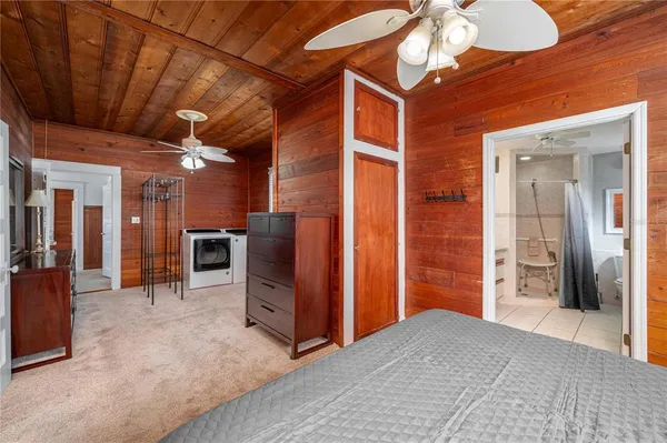 a view of a hallway with wooden cabinets