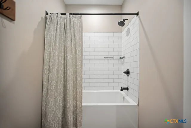 a view of a workspace with furniture and a flat screen tv