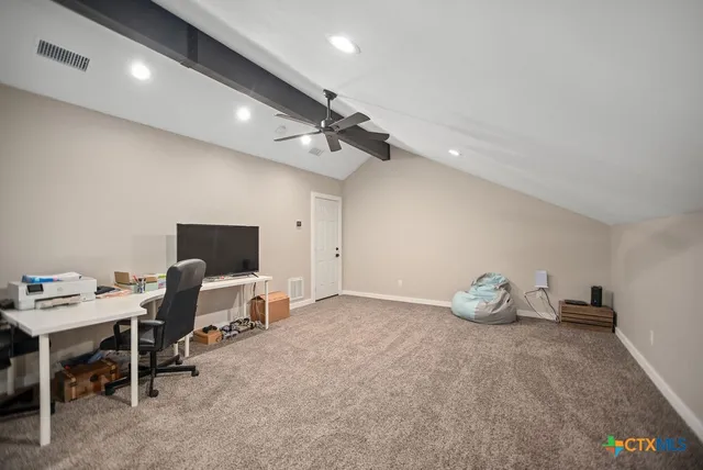 a view of a room with wooden floor and furniture