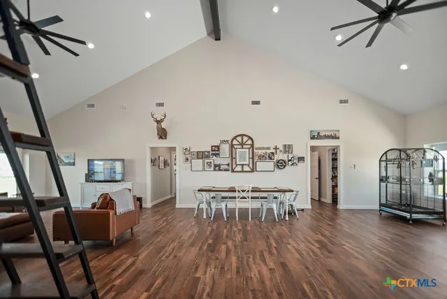 a living room with furniture a rug and white walls