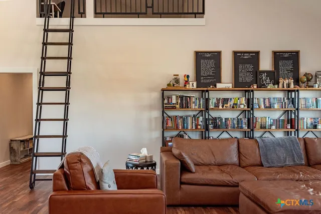a living room with furniture a dining table and chairs