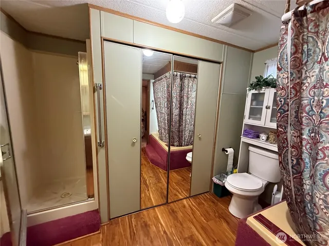 a bathroom with a toilet and a shower