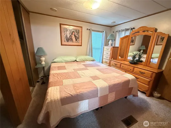 a bedroom with a bed and a mirror