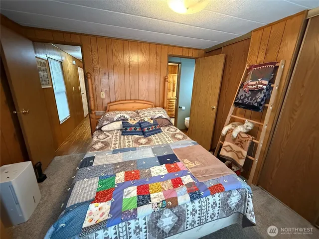 a bed sitting in a bedroom next to a window