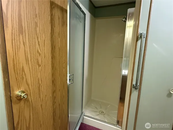a bathroom with a shower and a mirror