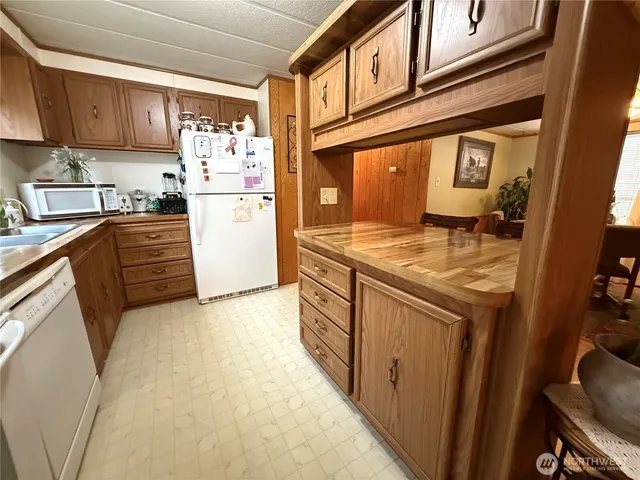 a kitchen with granite countertop cabinets and refrigerator