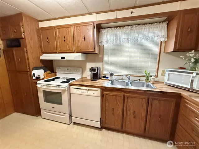 a kitchen with appliances cabinets and a sink