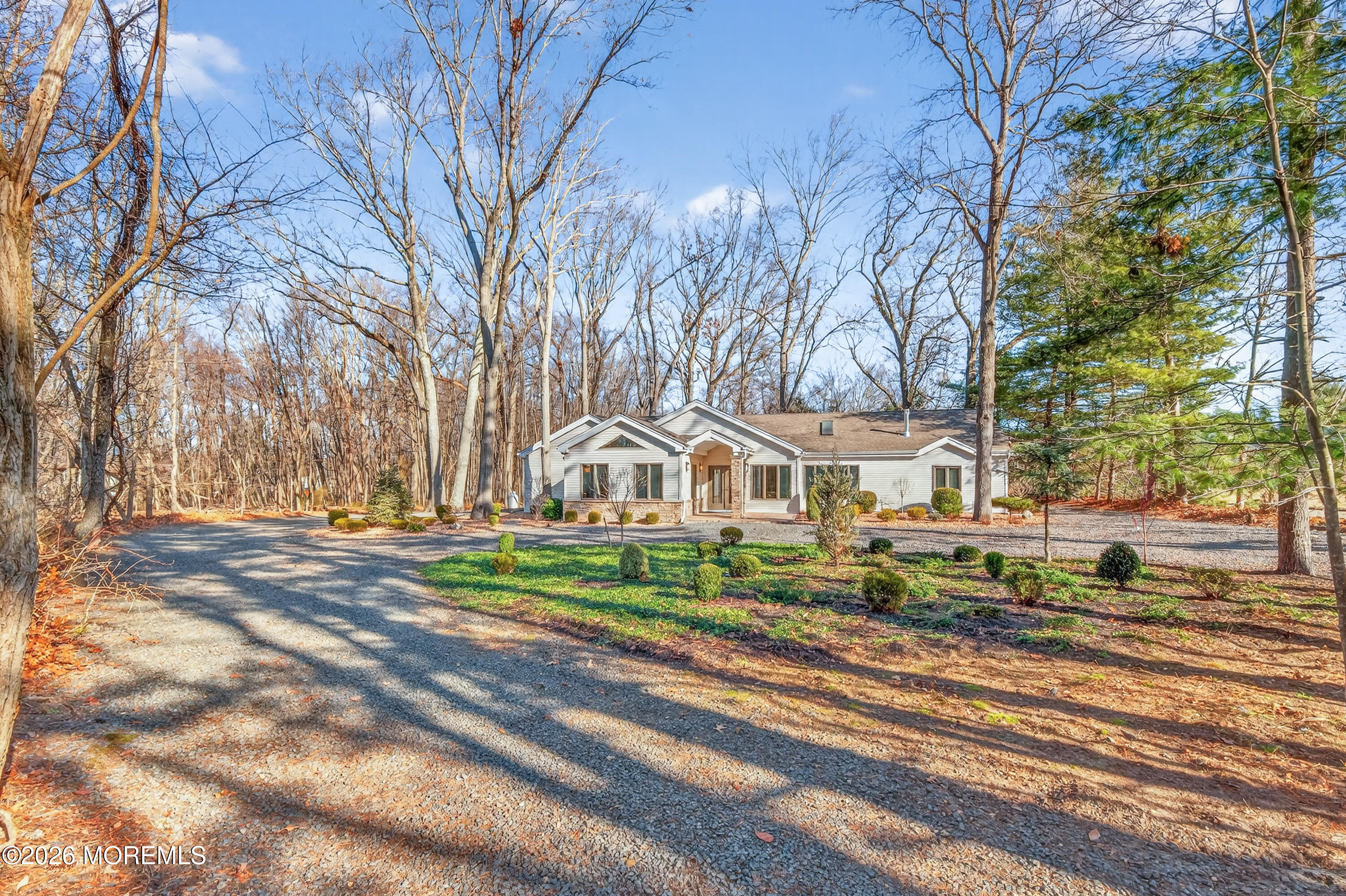 184 Smithburg Road Manalapan, NJ 07726 - Photo 15 of 45 a front view of a house with a yard and large trees